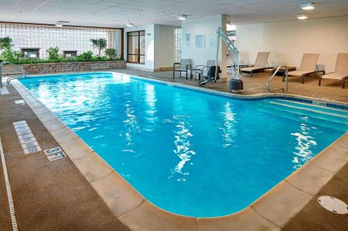 a large pool with blue water in a hotel room at Courtyard by Marriott State College in State College