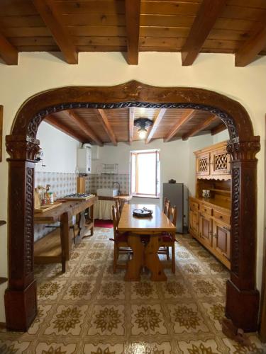 a kitchen with a wooden table in a room at Casa nel centro storico di Borno in Borno