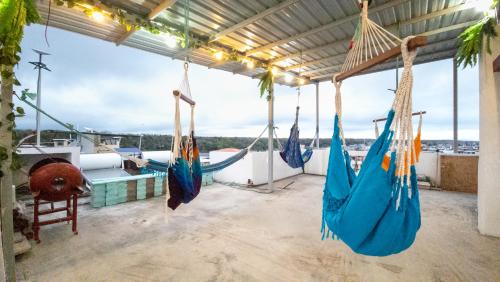 a porch with blue hammocks on a boat at Pacific Blue House in Puerto Ayora