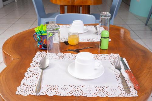 a table with plates and utensils on a table at Pacific Blue House in Puerto Ayora