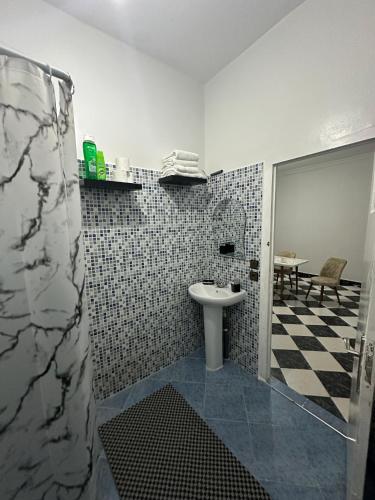 a bathroom with a sink and a shower at Ftouh House Heart of Tangier in Tangier