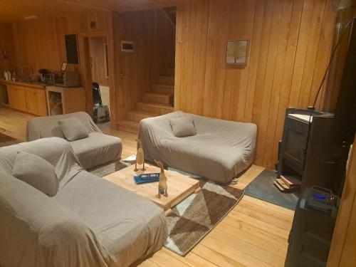 a living room with two beds and a tv at La gran escapada in Navidad