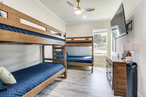 a bedroom with bunk beds and a desk at Steps to Beach Modern Gulfport Getaway! in Gulfport