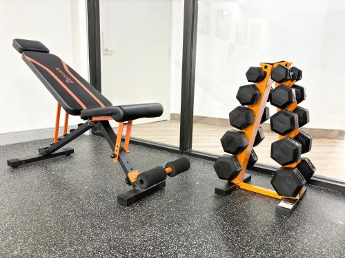 a gym with a chair and a rack of weights at Comfort Inn Marietta-Atlanta near Ballpark-Galleria in Marietta