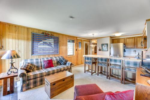 a living room with a couch and a kitchen at 2 Mi to Snowshoe Resort Townhome with Deck! in Dunmore