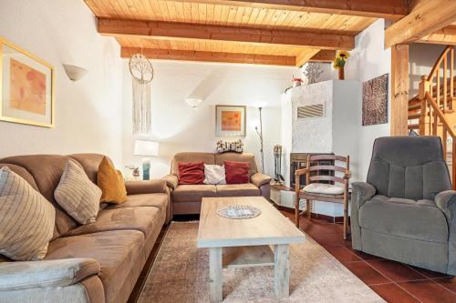a living room with a couch and two chairs and a table at Ferienhaus Fülling in Hooksiel