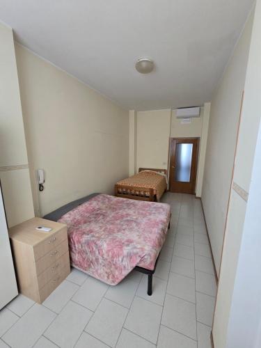 a bedroom with two beds and a dresser in it at Appartamento Mare in San Benedetto del Tronto