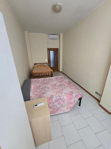 a bedroom with two beds and a dresser in it at Appartamento Mare in San Benedetto del Tronto