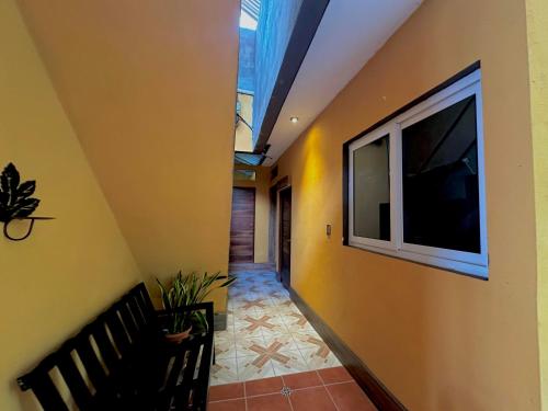a hallway with a flat screen tv on a wall at Hotel San Miguel in Flores