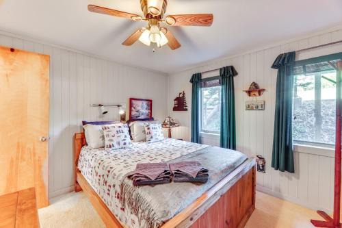 a bedroom with a bed with a ceiling fan at 2 Mi to Snowshoe Resort Townhome with Deck! in Dunmore