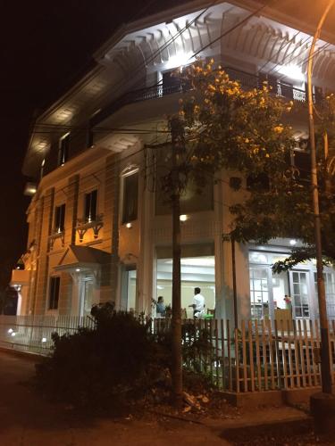 a man standing in front of a house at night at Daffodils Spice Court in Cochin
