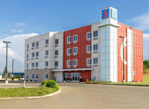 a building with a clock tower in front of it at Motel 6-Swift Current, SK in Swift Current