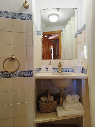 a bathroom with a sink and a mirror at Moinho da Alfazema in Penacova
