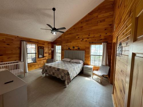 a bedroom with a bed and a ceiling fan at 2 Homes Laurel Canyon and Cherokee Oaks in Concan
