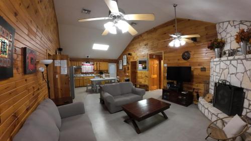 a living room with a couch and a tv at 2 Homes Laurel Canyon and Cherokee Oaks in Concan