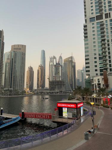 a view of a city with a river and buildings at Golden Hour Marina View in Dubai