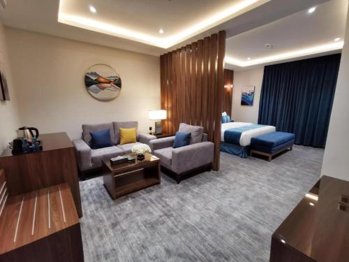 a hotel room with a couch and a bed at فندق امان - أحد رفيدة in Ahad Rafidah