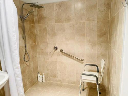 a shower with a chair in a bathroom at D130 The Link Fantasy Place in Keilor
