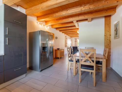 a kitchen and dining room with a table and a refrigerator at Maxima - Ski in - Ski Out in Flecken