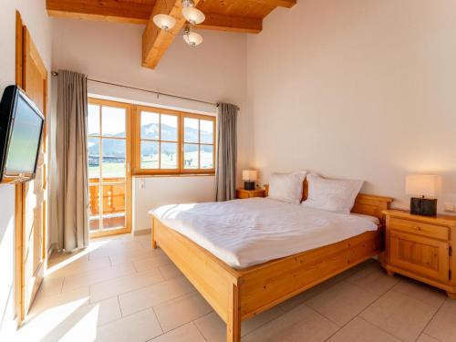 a bedroom with a large bed and a television at Maxima - Ski in - Ski Out in Flecken
