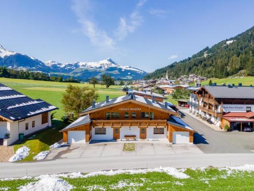 an aerial view of a building with mountains in the background at Maxima II - Ski in - Ski Out in Flecken