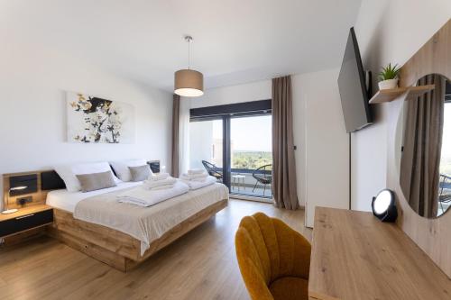 a bedroom with a bed and a television in it at Luxury villa with a swimming pool Primosten - 23550 in Primošten
