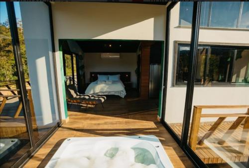 a bedroom with a bed and a tub in a room at Refúgio Paraíso Casa Splendore Spa Panorâmico in Orleans