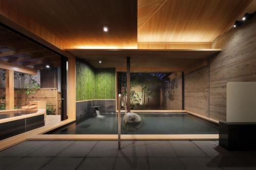 a swimming pool in the middle of a house at 天童荘 TENDOSO in Tendo