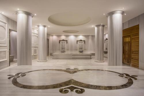 a lobby with columns and a table in the middle at IC Hotels Santai Family Resort - Kids Concept in Belek