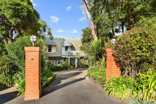 a house with a brick gate in front of a driveway at The Castle - Villa by the Sea in Cowes
