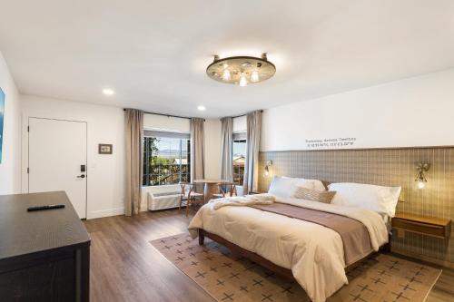a bedroom with a large bed and a desk at Inn History Tombstone in Tombstone