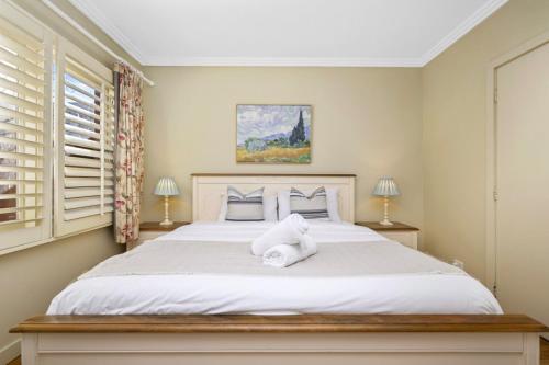 a bedroom with a bed with a teddy bear on it at Family 3BR 2-level Home at Central Chatswood in Sydney