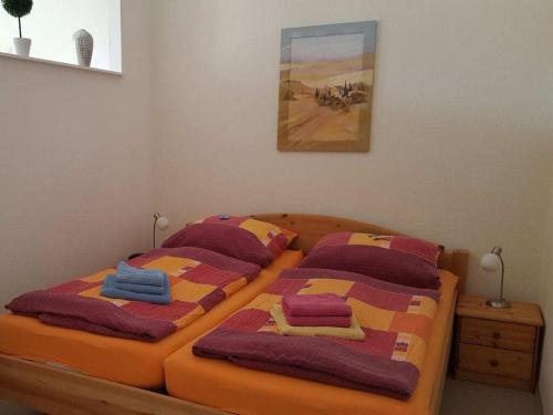 two twin beds in a bedroom with a picture on the wall at Holiday apartment in Waren Müritz in Waren