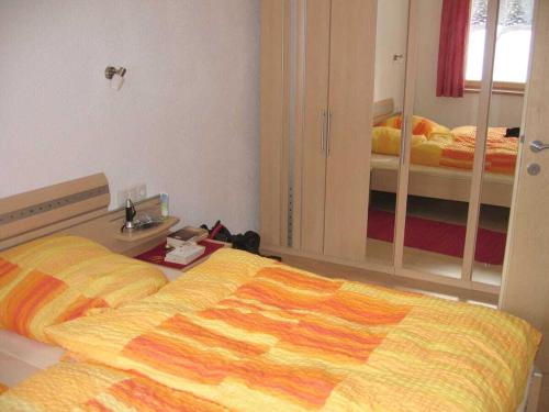 a bedroom with two beds and a mirror at Holiday Apartment, Apartment Melanie in Niederthai