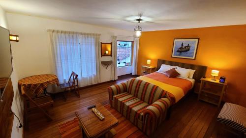 En eller flere senge i et værelse på 8a Cusco Guest House
