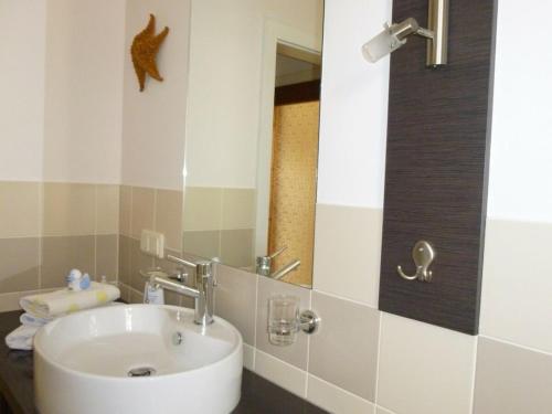 a bathroom with a sink and a mirror at Wiete Lenk Comfortable holiday residence in Dresden
