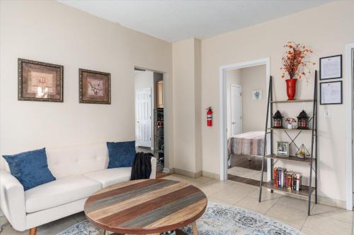 a living room with a couch and a table at Snapdragon Apt - Charming Two Bedroom in Corcoran Neighborhood in Minneapolis