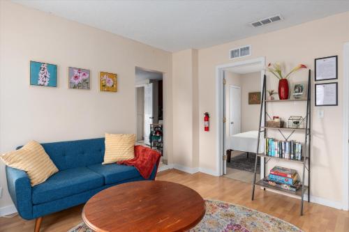 a living room with a blue couch and a table at 2BR Apartment with Private Office Near Downtown - Dahlia in Minneapolis
