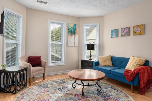 a living room with a blue couch and a table at 2BR Apartment with Private Office Near Downtown - Dahlia in Minneapolis