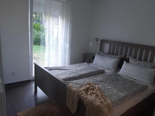 a bedroom with a large bed and a window at "thousand lakes" Comfortable holiday residence in Marienfelde