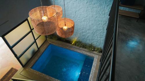 two chandeliers and a swimming pool in a room at Ecoparadise Hotel in Pereira