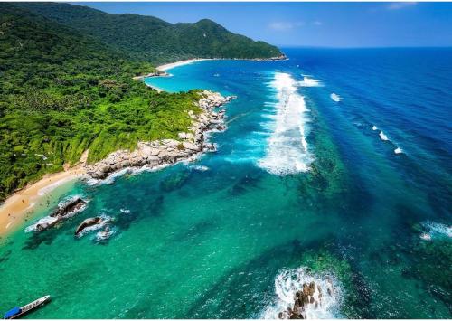an aerial view of a beach with boats in the water at Arrecifes Refugio Natural in Santa Marta