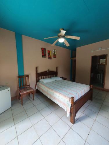 a bedroom with a bed and a ceiling fan at River Park Inn in San Ignacio