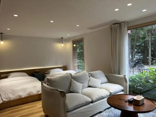a living room with a couch and a bed at Vretreats Suyunjian Boutique Hotel in Xinglong