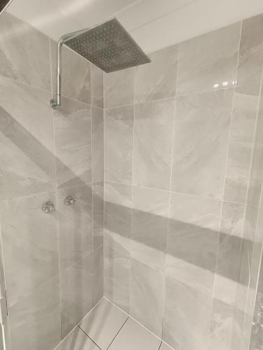 a bathroom with a shower with a glass door at Peaceful Room in Modern Baulkham Hills Home - BH3 in Baulkham Hills