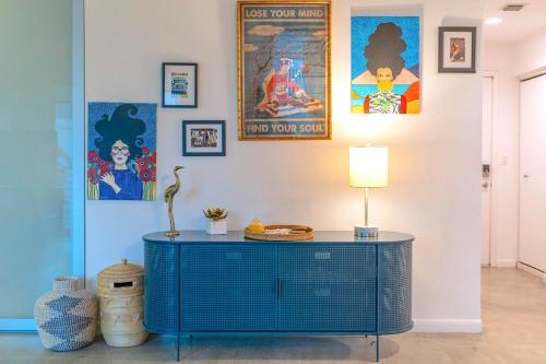 a blue cabinet in a room with paintings on the wall at City Loft - Downtown Bayfront pool gym & parking in Miami