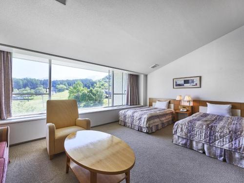 Postel nebo postele na pokoji v ubytování Hakuba Alps Hotel