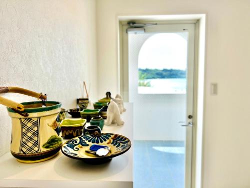 a group of bowls and plates on a counter at Aqua shallows in Onna