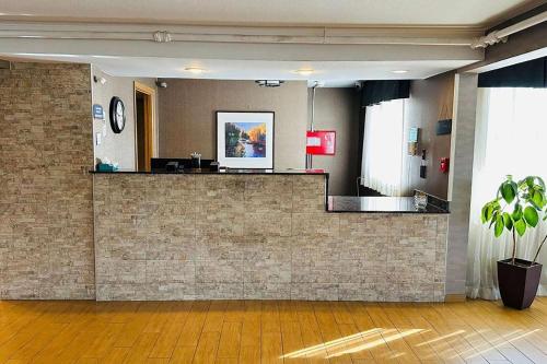 a lobby with a brick wall with a counter at Roosevelt Hotel in Williston