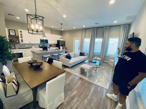 a man is standing in a living room at Hidden Gem - Gated Community & Garage Parking in Houston